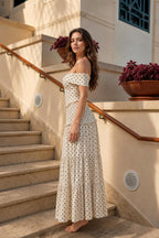 Model wearing cream polka dot maxi dress, side profile