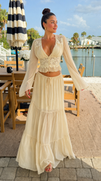 Full front view of cream boho two-piece skirt set with deep V neckline and flowing maxi skirt