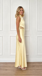 Side view of yellow satin maxi dress on model