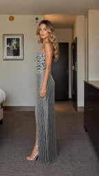 Side profile view of the silver crystal-embellished gown