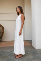 Side profile of woman in white maxi dress showing relaxed fit