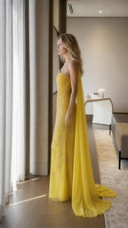 Side profile view of yellow evening gown