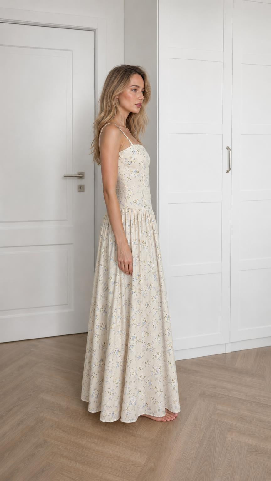 Side profile of woman wearing ivory floral maxi dress