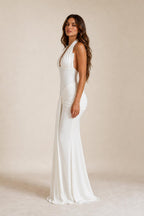 Side profile of woman in white halter evening gown