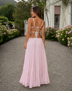 Back view of the striped cami top and blush pink maxi skirt set with tie-back detail