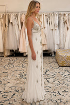Side profile view of ivory embellished evening gown