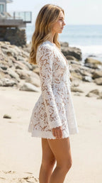 Side profile view of woman in white lace cover-up at the beach
