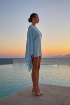 Model wearing light blue one-shoulder mini dress from side profile