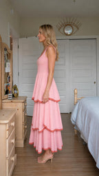 Side view of woman wearing pink tiered maxi dress