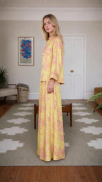 Side profile of woman wearing yellow floral brocade set