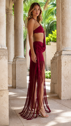 Side profile of woman in burgundy fringe skirt set