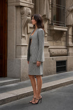 Side profile of model in black and white houndstooth suit set