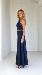Side profile of model wearing navy two-piece satin set