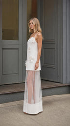Side profile view of white mesh layered maxi dress