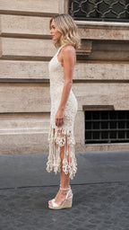Side profile view of beige crochet fringe midi dress