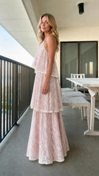 Side profile of model in pink lace maxi dress