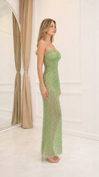 Side profile view of the green beaded gown