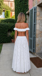 Back view of model in white lace matching set