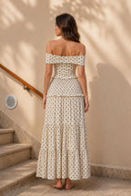 Model wearing cream polka dot maxi dress, back view