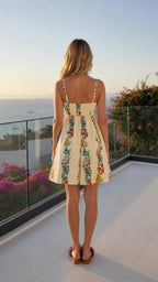 Back view of woman wearing ivory floral print mini sundress