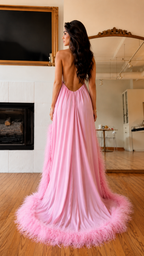 Back view of pink halter maxi dress with low open back and feathered train hem