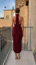 Back view showcasing halter neck scarf tie on burgundy midi dress