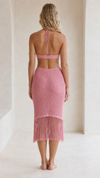 Back view of model showing open back design of pink fringe knit dress