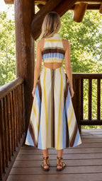 Back view of cream striped midi dress with open back detail