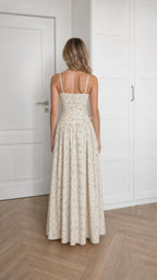 Back view of woman wearing ivory floral maxi dress