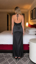Back view of black satin halter maxi dress showing open back design