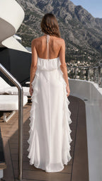 Back view of woman wearing White halter ruffle maxi dress