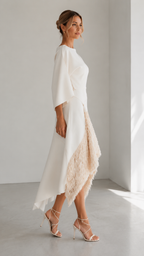 Side view of ivory occasion dress with flowing sleeve and angled hem