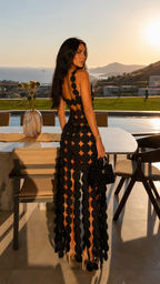Back view of black open back scalloped maxi dress with full-length silhouette