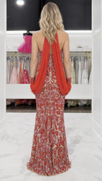 Back view showing draped detail on red evening gown