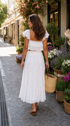 Back view of white two-piece skirt set with open back top detail