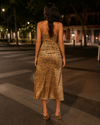 Back view of leopard print midi dress with slim straps and fitted silhouette