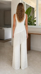 Back view of model in white wide-leg knit jumpsuit