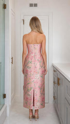 Back view of model wearing pink floral strapless midi dress