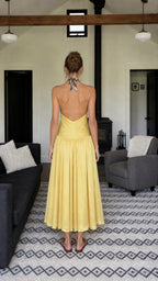 Back view of woman showing open-back halter design