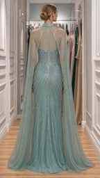 Back view showcasing the tulle cape and beaded detailing of the sage green gown