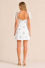 Back view of white mini dress with concealed zipper and tie shoulders