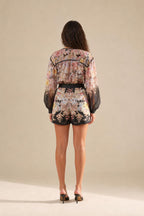 Back view of floral romper showing shorts length and overall fit