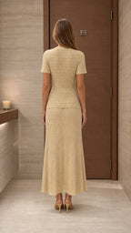 Model wearing beige knit two-piece set from the back