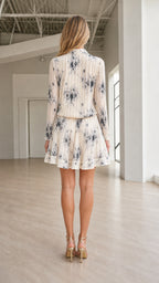 Back view of ivory pleated shirt dress with tie waist