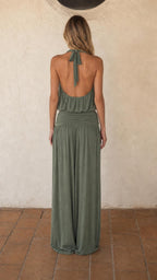 Back view of woman wearing sage green halter top and wide leg pants
