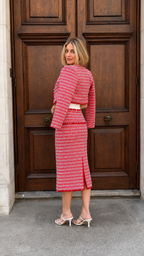Back view of red tweed-look midi skirt set showing cropped jacket and slim silhouette