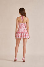 Back view of model wearing pink one-shoulder floral mini dress