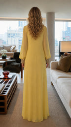 Back view of woman wearing yellow embroidered maxi dress