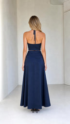 Back view of model wearing navy halter crop top and maxi skirt