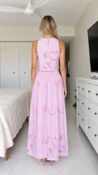 Back view of model in pink embroidered crop top and maxi skirt